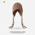 Braune gestrickte Winter Beanie Mütze mit stilvollen Quasten und Lochmuster für kalte Tage. - Quaste Langer Riemen / Khaki