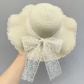 Close-up details of the summer beach straw hat featuring a delicate white lace bow. - M (56-58cm) / Leaf Floral Edge / Beige