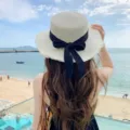 Women summer beach straw hat with black bow ribbon fringe flat top sunhat for vacation - One Size / Off White