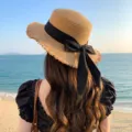 Japanese style straw hat with black ribbon bow, wide frayed brim for summer beach vacation. - One Size / Brown