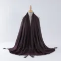 Detailed view of the dark long hijab scarf with silver wire rolled edges and tassel charms. - 9#