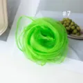 Detail shot of vibrant green chiffon square scarf, rolled in flower shape, lightweight fabric. - Size 7