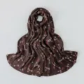 Detailed view of the dark brown floral silk scarf, showing delicate small flower print. - 180x70cm / #A10