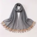 Detailed view of grey chiffon hijab scarf with sparkling sequin tassel trim border close up - A10