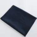 Detail view of the solid dark blue satin fabric, showing smooth texture for making. - 03 Dark Blue