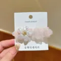 Exquisite pink mesh flower duckbill hair clip close-up showing fine pearl details on backing card. - Korean Pink Artificial Pearl Flower