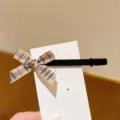 Close-up detail of a sweet plaid ribbon bow hair clip with black velvet, perfect for cute daily wear. - Black Velvet Khaki Plaid