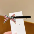 Detailed close-up shot of a sweet plaid ribbon bow hair clip with black velvet finish. - Black Velvet Multi Plaid