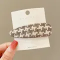 Detailed view of brown white houndstooth fabric hair clip, winter fashion side bang clip. - Teardrop / Brown Plaid