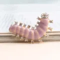 Close-up detail of the cute rhinestone caterpillar brooch with elegant enamel and sparkling crystals. - Gray