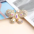 Exquisite rhinestone butterfly nail art accessory detail shot, featuring colorful sparkling crystal stones. - White AB