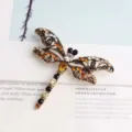 Vintage rhinestone dragonfly brooch detailed shot, elegant zinc alloy insect pin for women. - Coffee