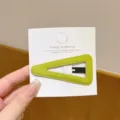 Close-up of a green velvet triangle hair clip on white card, elegant daily accessory detail. - Triangle / 1 Piece / Green