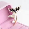 Exquisite fish tail brooch featuring sparkling rhinestones, black stones and a pearl detail. - Gold and Solid Black