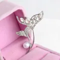 Exquisite silver-tone fish tail pearl brooch with sparkling crystals, elegant clothing accessory. - Silver & White