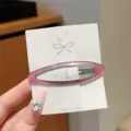 Minimalist translucent pink hollow oval hair clip detail view, elegant side bang snap hairpin. - Oval Hair Clip / Pink