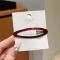 Red enamel cutout oval hair clip detail view, simple and elegant side hairpin for bangs. - Oval Hair Clip / Dark Red