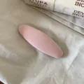 Gedetailleerd overzicht van roze stoffen ovale haarklem, eenvoudig effenkleurig ontwerp. - Waterdruppel Haarclip / Effen Roze