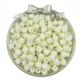 Close-up detail of 7x7mm acrylic square cube loose beads in pale yellow color with center hole for DIY. - 50 Pieces/Pack / Beige