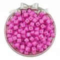 Close-up of pink acrylic cube beads in a decorative silver tray, ideal for DIY jewelry crafting. - 50 Pieces/Pack / Rose Red