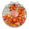 Detailed close-up view of mixed orange and clear acrylic DIY beads, charms and jewelry accessories. - Orange