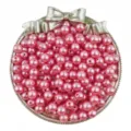 Detailed view of pink ABS imitation pearl beads in a decorative bow tray for DIY jewelry. - 3mm (300 Pieces/Pack) / Pink
