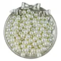 Detail shot of white ABS faux pearls with center holes in silver bow tray for DIY jewelry making. - 3mm (300 Pieces/Pack) / Off White
