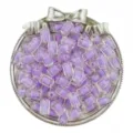 Gros plan sur des perles cylindriques en acrylique mauve de 12mm pour la création de bijoux DIY. - Lot de 30 / Violet