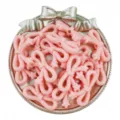 Detail shot of pink acrylic star bow beads, perfect for handmade DIY jewelry crafting. - Orange