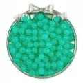 Close-up detail of translucent green acrylic jelly round beads inside a silver bow storage dish. - Fruit Green