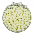 Close-up detail of white solid acrylic round beads without holes in a decorative tray. - 6mm 100 Pieces/Pack / Beige