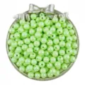 Detail shot of light green acrylic AB round beads in a silver bow tray for DIY jewelry crafts. - Light Green