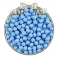 Detailed close-up of light blue acrylic solid round beads displayed in a decorative tray. - Blue