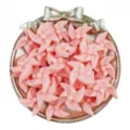 Pink acrylic pinwheel beads close up view, perfect for DIY handmade crafts and jewelry accessories. - Orange