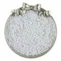 Detailed view of white glass seed beads in decorative silver tray for DIY jewelry making. - White