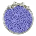 Detail shot of purple glass seed beads in decorative bow dish for DIY jewelry making. - Grey Blue