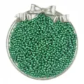 Close-up detail of sparkling green glass seed beads in a silver bow container for DIY craft. - Dark Green