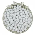 Close-up of white faceted acrylic beads in a silver bow tray, perfect for DIY jewelry making. - 50 Pieces/Pack / White