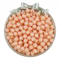 Closeup view of peach pink faceted acrylic beads in a silver tray for DIY handmade jewelry. - 50 Pieces/Pack / Orange