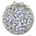 Close-up detail of white acrylic smiley face beads displayed in a decorative silver bowl. - White