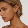 Close-up detail shot of multi-piece gold earrings set worn on ear, elegant and stylish design. - Combination Collection (JQH0111-143-376-W72) / 4 Pieces / Gold