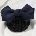 Detailed view of dark blue fabric bow hair net with black mesh pocket for professional wear. - Herringbone Blue Style B Coarse Mesh
