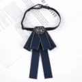 Detailed view of dark blue ribbon bow tie with sparkling crystal rhinestone center piece. - Grey Gemstone Blue Bow Tie