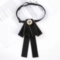Detailed view of women's black bow tie collar flower with pearl rhinestone center for uniform. - 6-Pearl Black Ribbon Bow Brooch