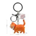 Simpatico portachiavi gatto arancione con ciondolo zampa, anello in metallo, borsa charm - 2ª Gen Gatto Tigrato Giallo / Zampa di Gatto Bianco