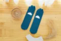 Close-up detail of soft blue fuzzy coral fleece sleep socks featuring cute rabbit ear design. - One Size / No. 1