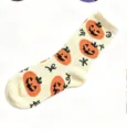 Close-up detail of Halloween plush sleeping socks with cute pumpkin pattern, cozy home wear. - Size 35-40 / Light Yellow
