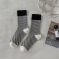 Close-up of black and white striped wool socks, ribbed cuffs, cozy winter style. - One Size / Striped Cuff with Black and White Heel