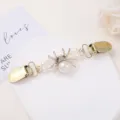 Exquisite pearl and rhinestone spider cardigan clip detail shot, elegant accessory. - Spider Style