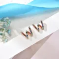 Colorful rhinestone letter W stud earrings detail, elegant minimalist copper jewelry design. - Letter W